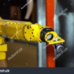 stock-photo-industrial-robot-with-cnc-machine-573087655
